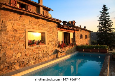 Typical holiday home with beautiful swimming pool in the evening sun. Tuscany, Italy