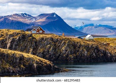 Typical Icelandic landscape with houses against mountains in small village of Stykkisholmur, Western Iceland - Powered by Shutterstock