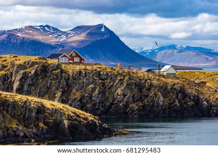 Typical Icelandic landscape with houses against mountains in small village of Stykkisholmur, Western Iceland