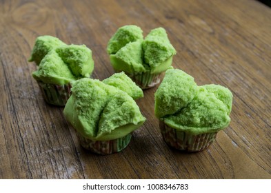 Typical Indonesian sweets green bolu kukus on table next to each other.