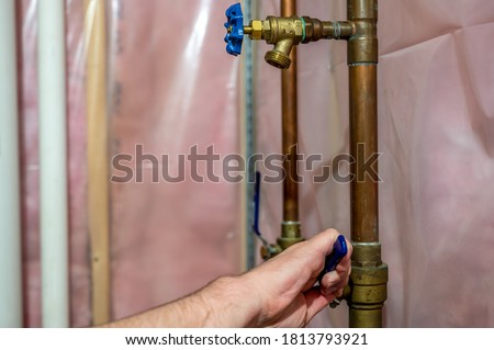 Typical installation of a sprinkler system connected to the main water system with a valve and drain.  
