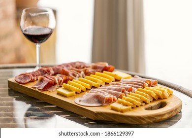 Typical Italian Aperitivo (or Antipasto). Salami And Cheese Plate With Mortadella And A Glass Of Wine. Perfect Set Up For Brunch, Apéritif And Digestif. The Perfect Meal To Stimulate The Appetite.