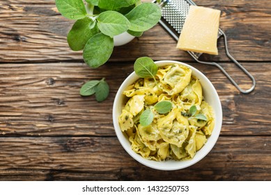 Typical italian pasta raviolli with sage and ricotta, rstic style and selective focus