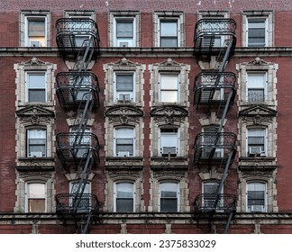 typical lower east side apartment building (tenement with fire escape, windows, lamp post) detail (red brick) - Powered by Shutterstock