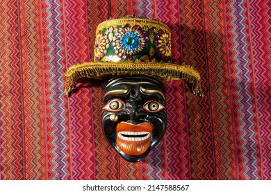 Typical Cusco´s mask Qhapaq Negro on a traditional peru fabric