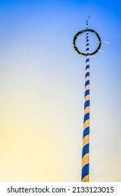 typical maypole in bavaria with the bavarian coat of arms - germany
