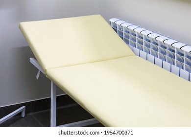 A typical medical bed in a doctors office. Background