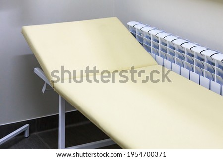 A typical medical bed in a doctors office. Background