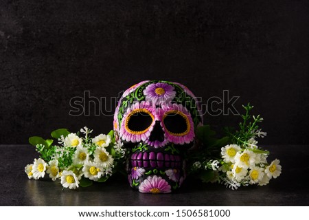 Typical Mexican skull with flowers painted on black background. Dia de los muertos. 