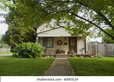 A Typical Middle Income Modern Day Home With A Green Lawn.