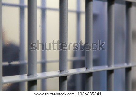 Typical modern prison bars. Symbolic illustrative background for crime news.
