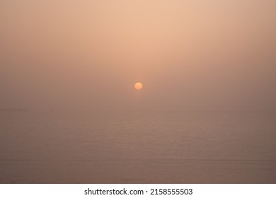 Typical mysty sunset at Arabian Gulf in the summer  Natural brown-yellow-red colortone without any manipulation