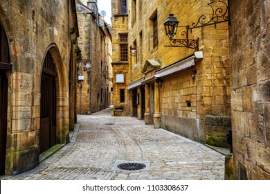 Typical Narrow Street In The Medieval Old Town Of Sarlat La Caneda, Perigord, France