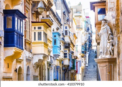 Typical narrow streets with colorful balconies in Valletta , Malta - Powered by Shutterstock