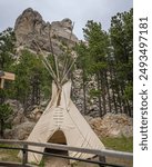 A typical Native American teepee below the side profile of George Washington at Mount Rushmore National Memorial