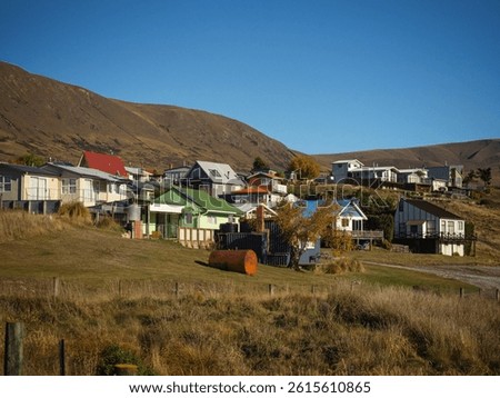 Typical New Zealand architecture house buildings at Lake Clearwater Village Town summer destination on golden grass hills at Ashburton Lakes Canterbury South Island