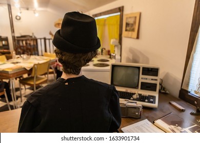 Typical Office Workspace In The 1980s With First Vintage PC. Female Mannequin In Casual Clothing Of The 80s. A Wax Figure Of Office Secretary