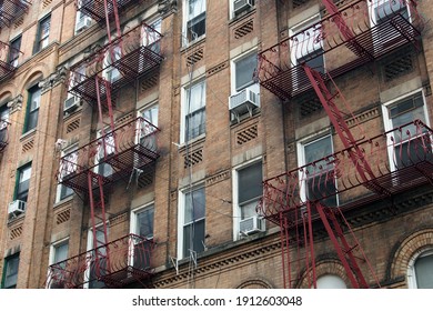 Typical old building facades with fire escapes in Manhattan, New York City