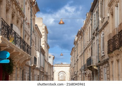 Typical old French residential buildings in Bordeaux, France, made of freestone, hosting flats, with a southwestern French architecture and the porte de Bourgogne gate. - Shutterstock ID 2168345961