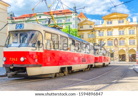 Typical old retro vintage tram on tracks near tram stop in the streets of Prague city near Sternberg palace in Lesser Town (Mala Strana) district, Bohemia, Czech Republic. Public transport concept.