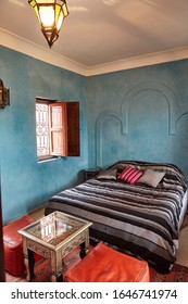 Typical Oriental Moroccan Style Bedroom Interior In Small Hotel In Morocco With Morrocan Pillows, Puffs And Table. Marrakech. Morocco