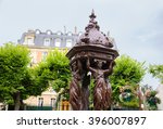 Typical Parisian drinking fountain with cast-iron women group at city square.