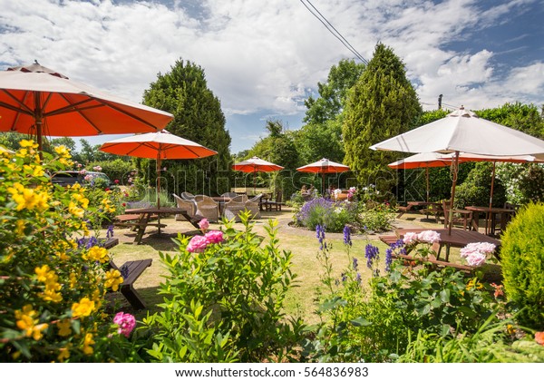 Typical pub garden\
in England on a summers\
day