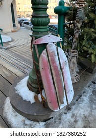 Typical Red Wooden Luge Sledge In The Street In Quebec Old City Downtown, Canada.