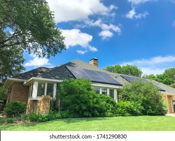 Typical residential house with solar panel on shingle roof in suburbs Dallas, Texas, America.