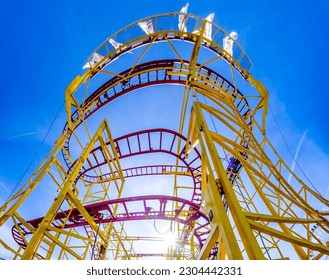 typical roller coaster in front of blue sky - photo