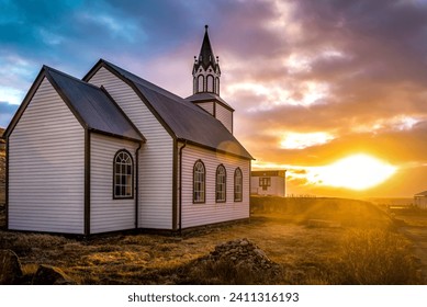 Typical rural Icelandic Church at sea coastline on sunset or sunrise. Religion theme - Powered by Shutterstock