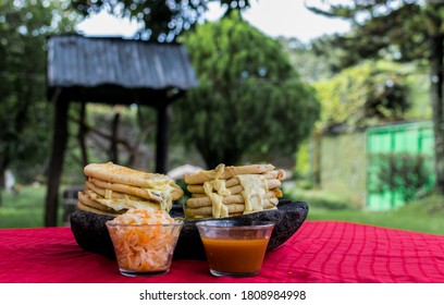 typical Salvadoran dish, cheese pupusas with cabbage and tomato sauce. rice and corn pupusas stuffed with cheese, beans or other ingredients - Shutterstock ID 1808984998