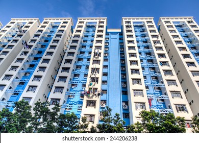 A Typical Singapore Highrise Public Housing Estate Against A Blue Sky.