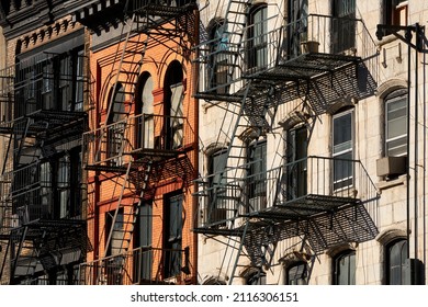 Typical Soho Loft Building Facades With Fire Escapes And Red Bricks. Manhattan, New York City