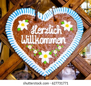 typical souvenir at the oktoberfest in munich - a gingerbread heart - lebkuchenherz - translation: welcome