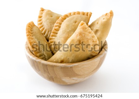 Typical Spanish empanadas in bowl isolated on white background
