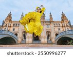 Typical Spanish girl very happy in the scuare from Spain in Seville, doing a flamenco pose with great art.