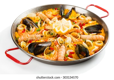 Typical spanish seafood paella in traditional pan isolated on white background