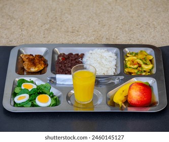 Typical steel tray with nutritious rustic food. Traditional university and popular tray