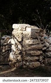 typical stone gate post with irongate and trees in the background