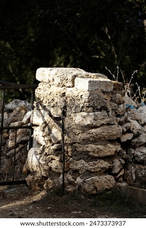 typical stone gate post with irongate and trees in the background