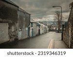 Typical street in city of Derry or Londonderry, visible lower part of the town and classical cloudy and a bit rainy weather in early spring.