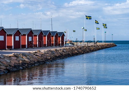 Typical Swedish west coastal environment with red boathouses, bridges and happy summer guests enjoying the perfect weather.
