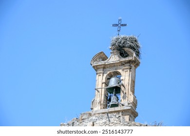 Typical top of a church bell and christian cross on a sunny day