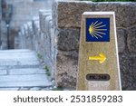 Typical waymark showing the direction of the way of Saint James to the destination Santiago de Compostela cathedral, this marker stays at the cathedral of Porto, Portugal