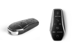 Typical Wireless Car Key Isolated On White Background. Remote Car Key For EV Vehicle.