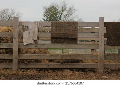 Typical Wooden Fence Down On The Farm With Dirty Towels And Laundry Air Drying From The Railing.