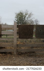 Typical Wooden Fence Down On The Farm With Dirty Towels And Laundry Air Drying From The Railing.