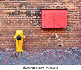 Typical yellow fire hydrant and box for fire-fighting equipment.