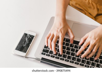 typing computer with crack mobile phone